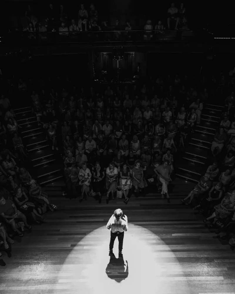 A lone speaker under the stage lights