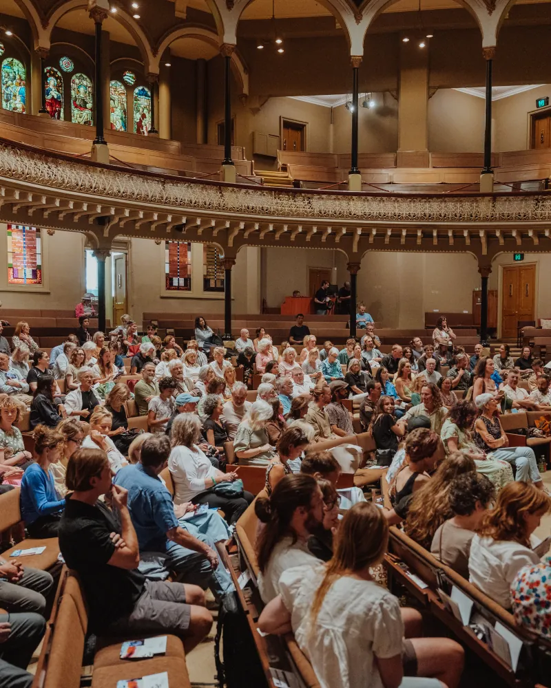 Audience in a candlelit hall