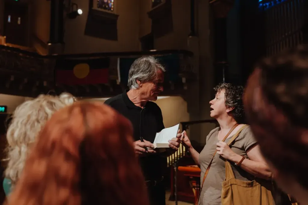 Two guests in close conversation at a Humans of Purpose gathering.